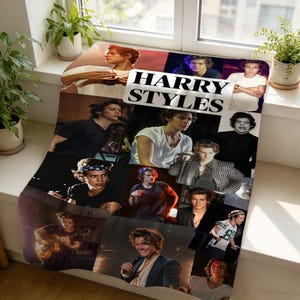 May include: A soft throw blanket featuring a collage of various photographs of Harry Styles performing on stage and in casual settings. The text "HARRY STYLES" is printed in bold black capital letters across the center of the fabric design.