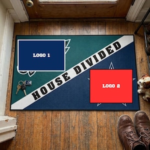 May include: A rectangular doormat featuring a diagonal white stripe with the text HOUSE DIVIDED in black letters. The mat is split into a dark teal section with a blue rectangular logo and a dark blue section with a red rectangular logo.