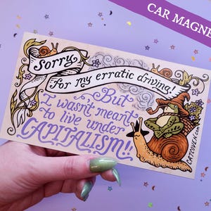 Könnte beinhalten: Rechteckiger Autoaufkleber mit einem skurrilen Design. Der Aufkleber zeigt eine Schnecke und einen Frosch mit Pfeife und den Text "Sorry for my erratic driving! But I wasn't meant to live under CAPITALISM!!"