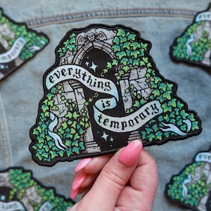 May include: Embroidered patch with the text "everything is temporary" on a banner. The patch features a gothic archway design with ivy and a bat. The patch is black, green, and white.