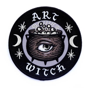 May include: Black and white embroidered patch with a cauldron, stars, moons, and the text "Art Witch".