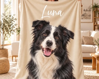 May include: A beige fleece blanket featuring a large, detailed photographic print of a black and white Border Collie dog with its mouth open. The name Luna is printed in white cursive script above the dog's head on the fabric.