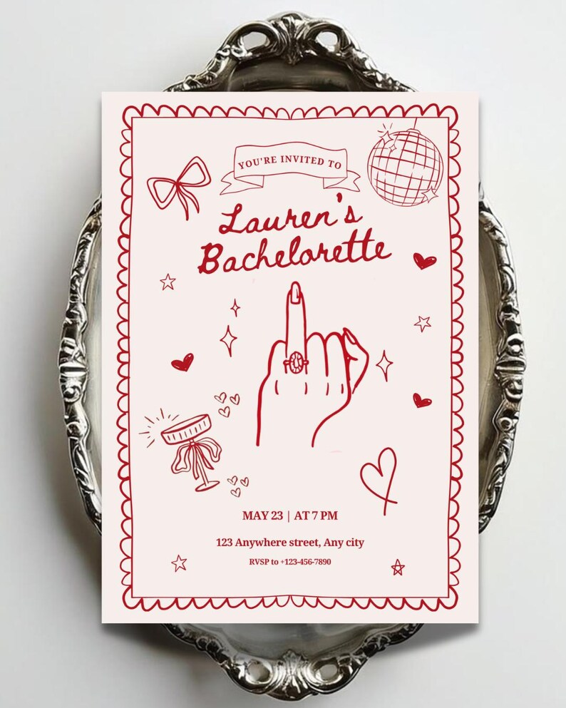 May include: A rectangular invitation card with a light pink background and red line art. It features a hand showing a middle finger with a ring, a disco ball, a bow, and hearts. Text reads: YOU'RE INVITED TO Lauren's Bachelorette MAY 23 | AT 7 PM.