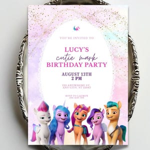 May include: A rectangular birthday party invitation featuring a pastel pink and purple watercolor background with gold glitter accents. The text reads: YOU'RE INVITED TO LUCY'S cutie mark BIRTHDAY PARTY AUGUST 13TH 2 PM 123 ANYWHERE ST, ANY CITY, ST 12345 RSVP TO LAUREN 123-456-789. Five colorful cartoon ponies are illustrated at the bottom.
