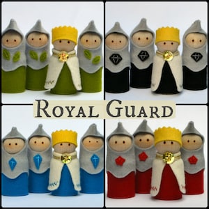 May include: Five felt finger puppets depicting a royal guard. The king is wearing a yellow crown and a white robe with gold trim. The guards are wearing grey helmets and tunics with different coloured accents: green, black, blue, and red.