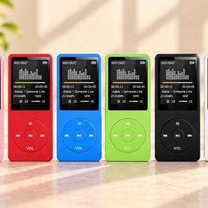 May include: Six portable digital music players in pink, red, blue, green, black, and white. Each device features a rectangular screen displaying a graphic equalizer, track information for Adele, and a circular control pad with M, play, and volume buttons.
