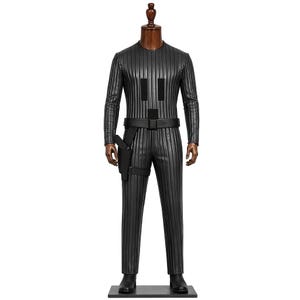Puede incluir: Un mono negro de manga larga con textura de rayas verticales, cuello redondo y cintura ajustada. La prenda incluye un cinturón utilitario negro con una funda sujeta en el lado derecho y dos parches rectangulares de color negro en el pecho.