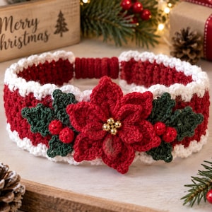 May include: A red and white crocheted headband featuring a large, central red poinsettia flower with a gold beaded center, flanked by dark green crocheted leaves and small red berries on each side, finished with a white scalloped edge trim.