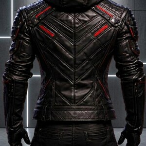 May include: A black leather hooded jacket featuring a quilted chevron pattern on the back, red accent stripes, and structured shoulder panels. The jacket is paired with matching black leather pants, creating a cohesive, dark, and textured ensemble.