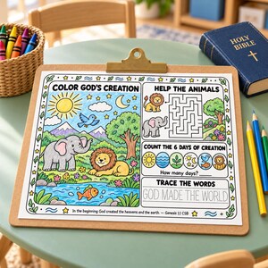 May include: A clipboard holds a printed activity sheet titled Color God's Creation, featuring a colored illustration of a lion, elephant, and fish in a landscape, a maze, a counting section, and the text Trace the Words God Made The World.