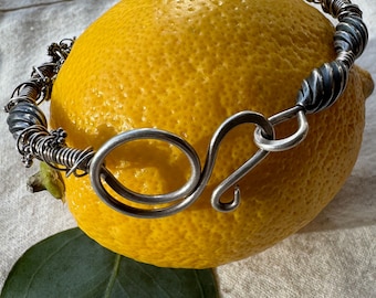 Wire wrapped sterling silver bangle bracelet with swirl clasp