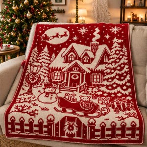 May include: A rectangular knit throw blanket featuring a two-tone red and white Christmas scene. The design displays a house, a snowman, a sleigh with a bear, wrapped gifts, a fence, and a silhouette of Santa in a sleigh against a moon.