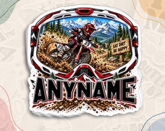 May include: A die-cut sticker featuring a red and white motocross goggle frame enclosing a scene of a rider on a dirt bike kicking up mud. The scene includes snow-capped mountains, pine trees, and a wooden sign reading EAT DIRT BE HAPPY. The word ANYNAME is printed in large black letters at the bottom.