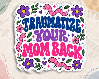 May include: A die-cut sticker featuring the text TRAUMATIZE YOUR MOM BACK in bold blue, purple, and pink wavy lettering. The design is decorated with three pink and purple striped worms, purple flowers with yellow centers, small green leaves, and tiny purple hearts and stars.