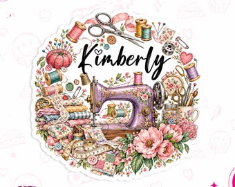 May include: A circular sticker featuring the name Kimberly in black script, surrounded by a purple sewing machine, stacks of patterned fabric, a pink pincushion, scissors, spools of thread, buttons, a measuring tape, and pink flowers.
