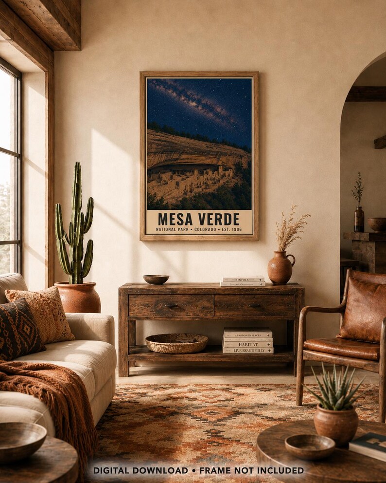 May include: A rectangular wall art print featuring a night sky filled with stars above the cliff dwellings of Mesa Verde National Park, Colorado. The poster includes the text MESA VERDE NATIONAL PARK COLORADO EST. 1906 in a bold font.
