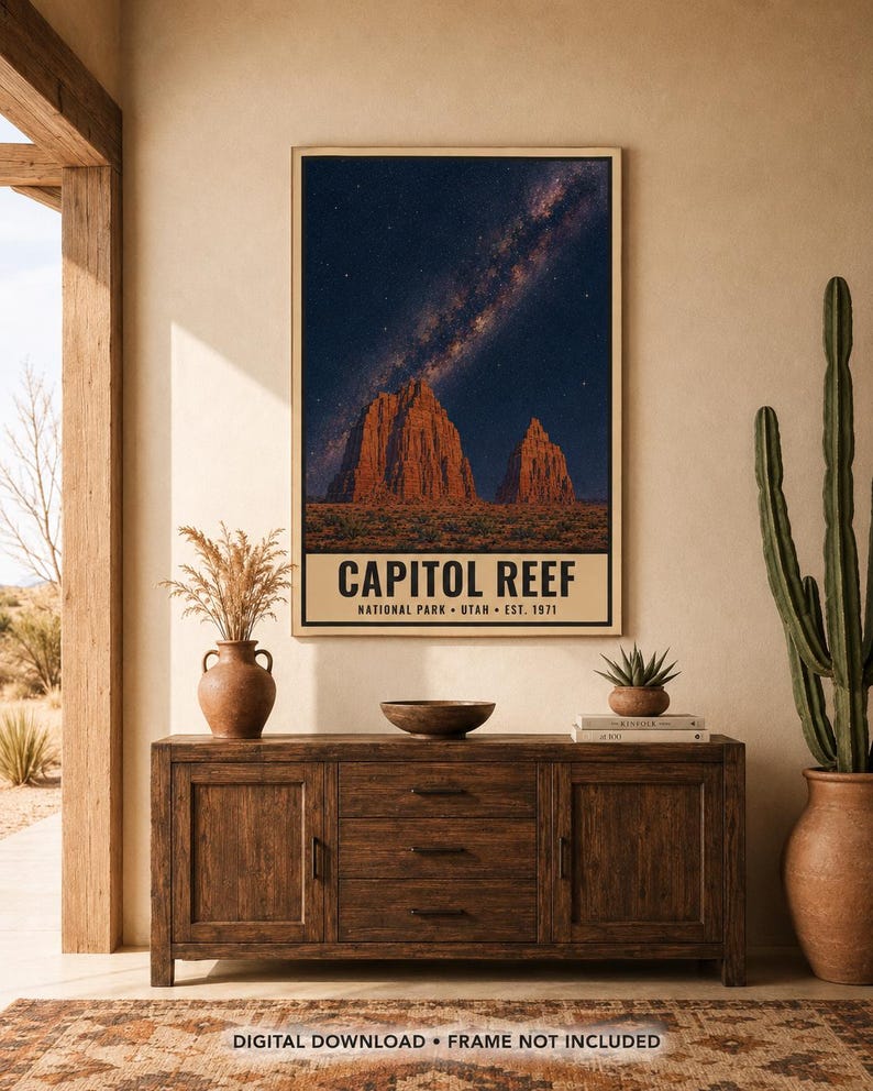 May include: A vertical wall art print featuring a night sky with a visible Milky Way galaxy above the red rock formations of Capitol Reef National Park. The text at the bottom reads CAPITOL REEF NATIONAL PARK UTAH EST. 1971 in a bold font.