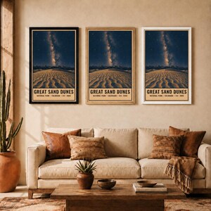 May include: Three vertical wall art prints featuring the Great Sand Dunes National Park in Colorado, established in 2004. Each print displays a night sky with the Milky Way over sand dunes, framed in black, light wood, and white frames respectively.