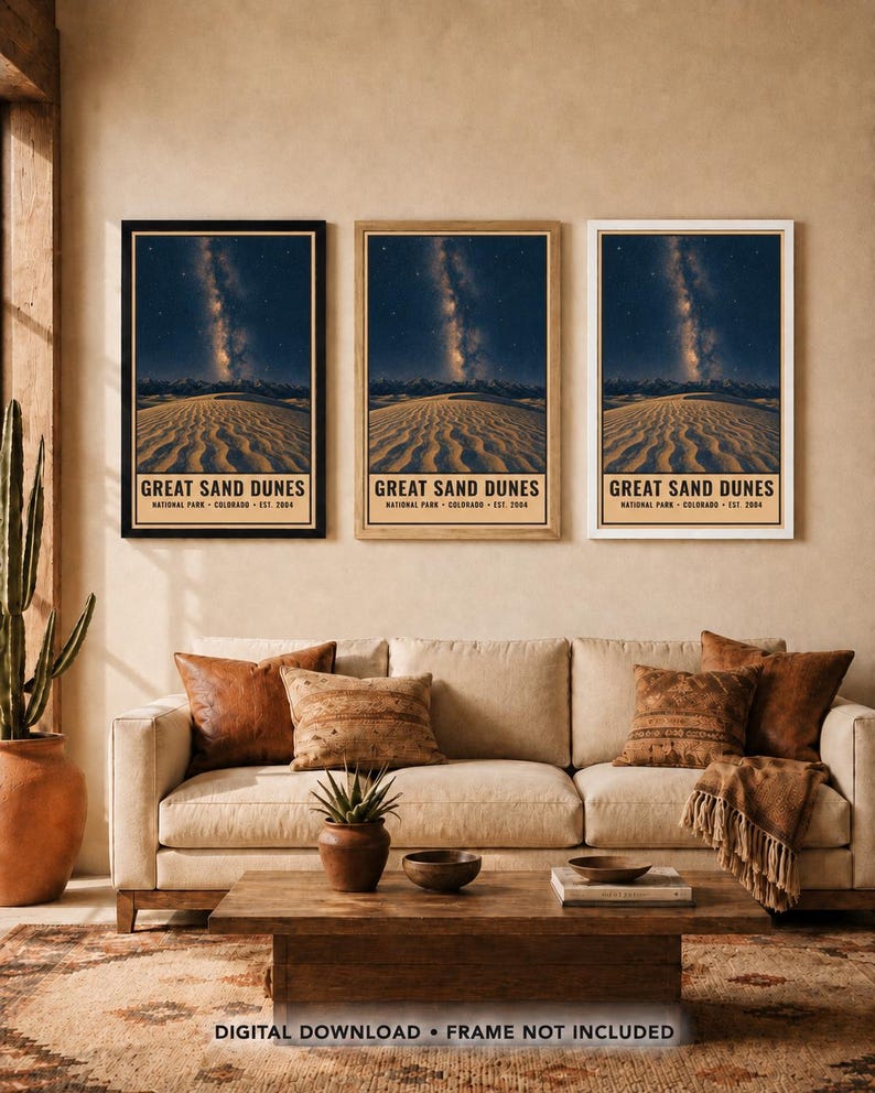 May include: Three vertical wall art prints featuring the Great Sand Dunes National Park in Colorado, established in 2004. Each print displays a night sky with the Milky Way over sand dunes, framed in black, light wood, and white frames respectively.