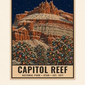 May include: A poster featuring a snow-covered red rock mountain formation under a starry night sky. In the foreground, snow-dusted trees are decorated with colorful string lights. The text reads CAPITOL REEF NATIONAL PARK UTAH EST. 1971.
