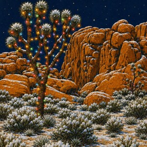 May include: A desert landscape at night featuring a Joshua tree decorated with multicolored string lights. The ground and low-lying desert shrubs are covered in a light dusting of snow, set against large orange rock formations and a dark starry sky.