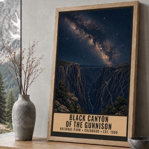 May include: A vertical rectangular wall art print featuring a night sky with a visible Milky Way galaxy above the deep, dark rock formations of the Black Canyon of the Gunnison. The text reads: BLACK CANYON OF THE GUNNISON NATIONAL PARK COLORADO EST. 1999.