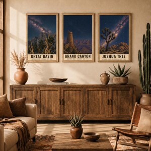 May include: Three vertical wall art prints featuring night sky landscapes of Great Basin, Grand Canyon, and Joshua Tree National Parks. Each print displays a starry galaxy above desert terrain with text identifying the park, state, and year established.