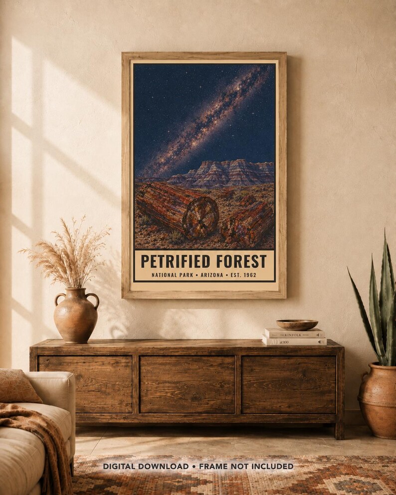 May include: A vertical wall art print featuring a night sky with a visible Milky Way galaxy above a desert landscape with petrified wood logs. The text reads PETRIFIED FOREST NATIONAL PARK ARIZONA EST. 1962 in black lettering on a cream background.
