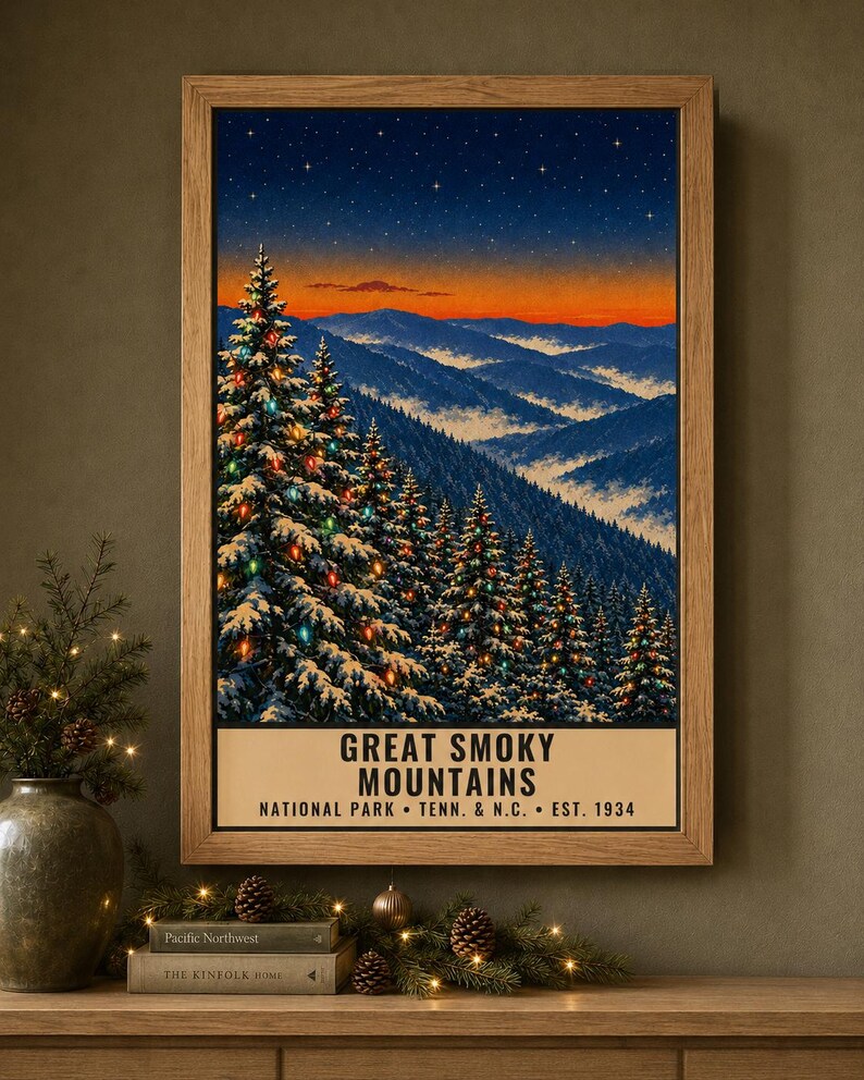 May include: A framed vertical poster depicting the Great Smoky Mountains at twilight. The scene features snow-covered pine trees decorated with colorful lights against a backdrop of blue mountain ridges and a vibrant orange sunset sky.
