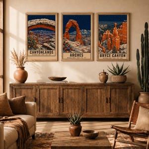 May include: Three vertical wall art prints featuring winter scenes of Canyonlands, Arches, and Bryce Canyon National Parks. Each print displays a dark blue night sky, snow-covered landscapes, and a decorated Christmas tree in the foreground.