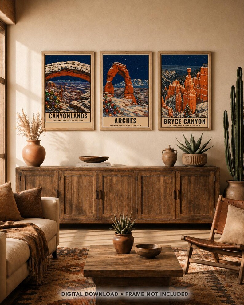May include: Three vertical wall art prints featuring winter scenes of Canyonlands, Arches, and Bryce Canyon National Parks. Each print displays a dark blue night sky, snow-covered landscapes, and a decorated Christmas tree in the foreground.