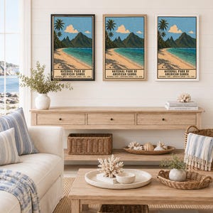 May include: Three vertical wall art prints depicting the National Park of American Samoa with palm trees, a sandy beach, and mountains. Each print features the text National Park of American Samoa, American Samoa, Est. 1988 in black frames.