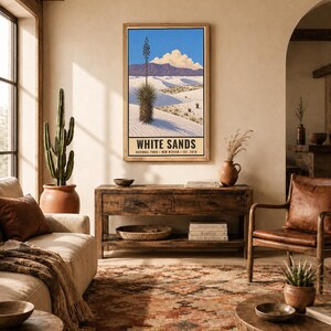 May include: A vertical rectangular wall art print featuring a landscape of White Sands National Park in New Mexico. The illustration depicts white gypsum dunes, a tall yucca plant, purple mountains, and a blue sky. Text reads WHITE SANDS.