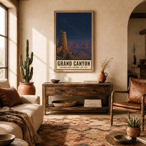 May include: A vertical rectangular wall art print featuring a night scene of the Grand Canyon with the Desert View Watchtower under a starry sky. The text reads GRAND CANYON NATIONAL PARK ARIZONA EST. 1919. The print is displayed in a wooden frame.