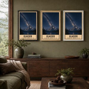 May include: Three vertical wall art prints featuring a night landscape of Glacier National Park, Montana, with a starry sky, mountain, and lake. Each print includes the text GLACIER NATIONAL PARK MONTANA EST. 1910 in a cream-colored border.