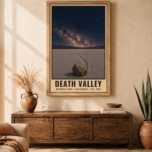 May include: A vertical wall art print featuring a night sky over Death Valley, California. The image shows a desert landscape with a rock and its trail in the foreground, beneath a starry Milky Way. The text reads DEATH VALLEY NATIONAL PARK CALIFORNIA EST. 1994.