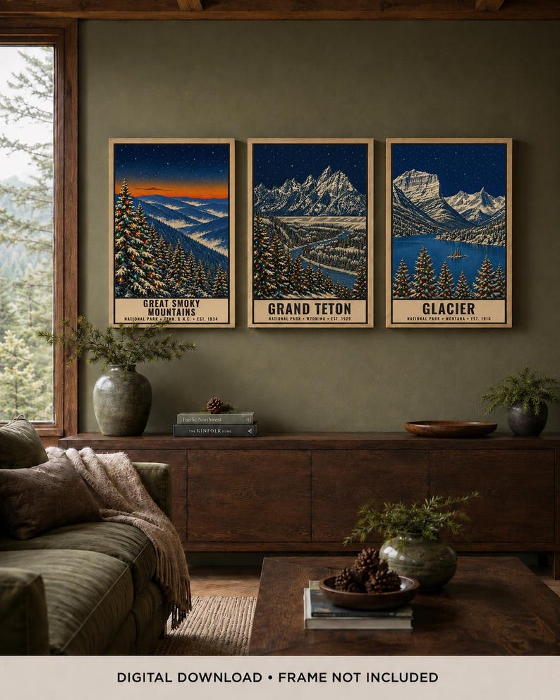May include: A set of three vertical art prints featuring illustrations of Great Smoky Mountains, Grand Teton, and Glacier national parks. Each print displays a snowy mountain landscape at night under a starry sky with text at the bottom.