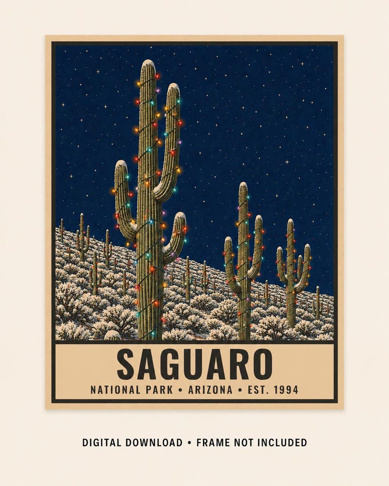 May include: A poster featuring a night scene of saguaro cacti in a snowy desert landscape, decorated with colorful string lights under a starry sky. The text reads SAGUARO NATIONAL PARK ARIZONA EST. 1994. DIGITAL DOWNLOAD FRAME NOT INCLUDED.