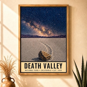 May include: A framed poster featuring a night landscape of Death Valley with a rock on a cracked desert floor, a trail behind it, and a starry sky. The text reads: DEATH VALLEY NATIONAL PARK &bull; CALIFORNIA &bull; EST. 1994 in black on a cream background.