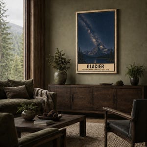 May include: A vertical rectangular wall art print featuring a night landscape of a mountain peak under a starry sky with a visible Milky Way galaxy. The text GLACIER NATIONAL PARK MONTANA EST. 1910 is printed in black at the bottom of the poster.