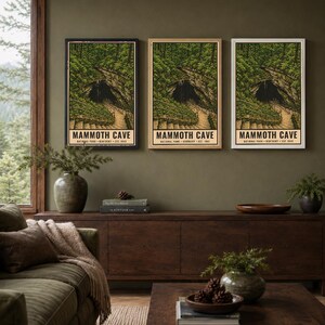 May include: Three vertical rectangular wall art prints featuring a detailed illustration of Mammoth Cave National Park in Kentucky, established in 1941. The artwork depicts a dark cave entrance surrounded by lush green trees and a stone staircase.