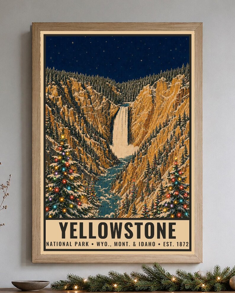 May include: A framed vertical poster depicting a winter landscape of Yellowstone National Park with a waterfall, snow-covered cliffs, and two pine trees decorated with colorful lights under a starry night sky. The text reads YELLOWSTONE NATIONAL PARK &bull; WYO., MONT. & IDAHO &bull; EST. 1872.