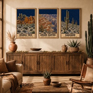 May include: Three framed vertical wall art prints depicting Joshua Tree, Grand Canyon, and Saguaro National Parks at night. Each print features a dark blue starry sky above a desert landscape with text at the bottom. Digital download, frame not included.