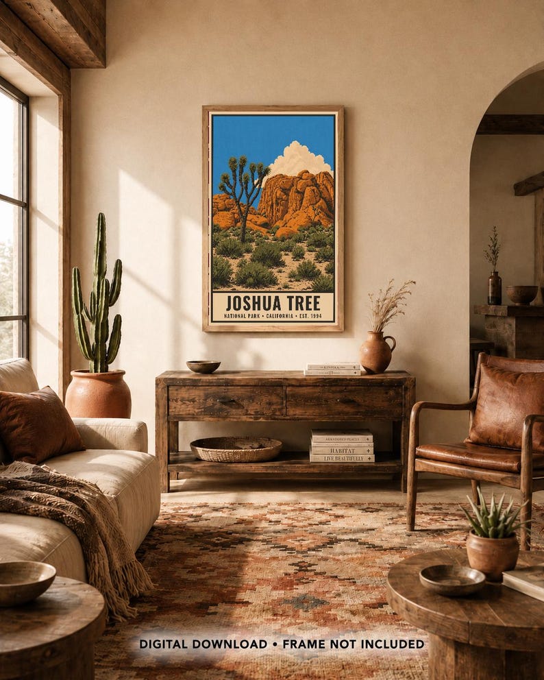 May include: A rectangular wall art print featuring a desert landscape with a Joshua tree, orange rock formations, and a white cloud against a blue sky. The text JOSHUA TREE NATIONAL PARK CALIFORNIA EST. 1994 is printed at the bottom of the poster.