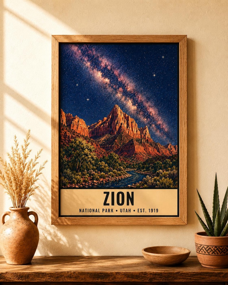 May include: A framed vertical wall art print featuring a night landscape of Zion National Park with red rock mountains, a river, and a starry sky with the Milky Way. The text reads ZION NATIONAL PARK &bull; UTAH &bull; EST. 1919 in black capital letters.