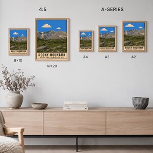 May include: A collection of Rocky Mountain National Park posters in various sizes including 8x10, 16x20, A4, A3, and A2. Each print features a mountain landscape with a blue sky, clouds, and rocky terrain. The text reads Rocky Mountain National Park.