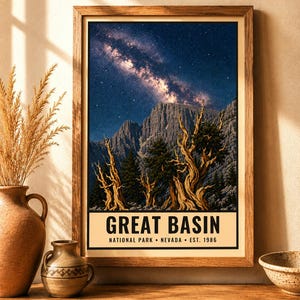 May include: A framed vertical poster featuring a night sky with a visible Milky Way galaxy above rugged mountains and twisted ancient trees. The bottom section contains the text GREAT BASIN NATIONAL PARK NEVADA EST. 1986 in black lettering.