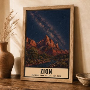 May include: A framed vertical wall art print depicting a night landscape of Zion National Park with a starry sky, red rock mountains, and a river. The bottom cream-colored banner features the text: ZION NATIONAL PARK &bull; UTAH &bull; EST. 1919.