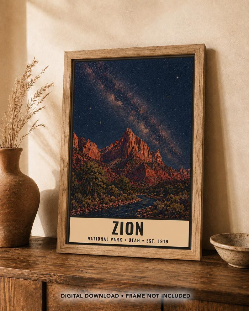 May include: A framed vertical wall art print depicting a night landscape of Zion National Park with a starry sky, red rock mountains, and a river. The bottom cream-colored banner features the text: ZION NATIONAL PARK &bull; UTAH &bull; EST. 1919.