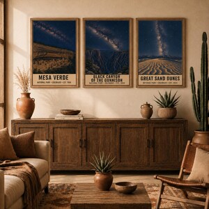 May include: A set of three vertical wall art prints featuring Mesa Verde, Black Canyon of the Gunnison, and Great Sand Dunes National Parks. Each print displays a night sky with a visible Milky Way over the landscape and text at the bottom.
